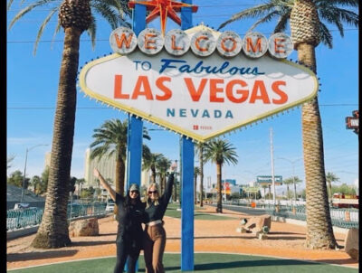 Two people in front of the Las Vegas sign